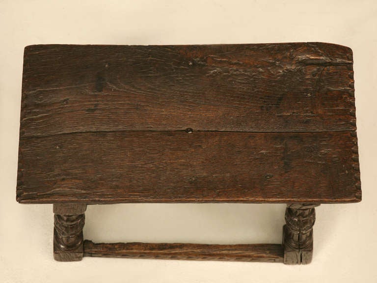 Residing in a 12th century Narbonne, France chateau for a number of years, this 17th century English oak stool is full of character and uses. Though a bit rustic, this sturdy stool, bench or table has great carved stretchers, aprons and turned legs