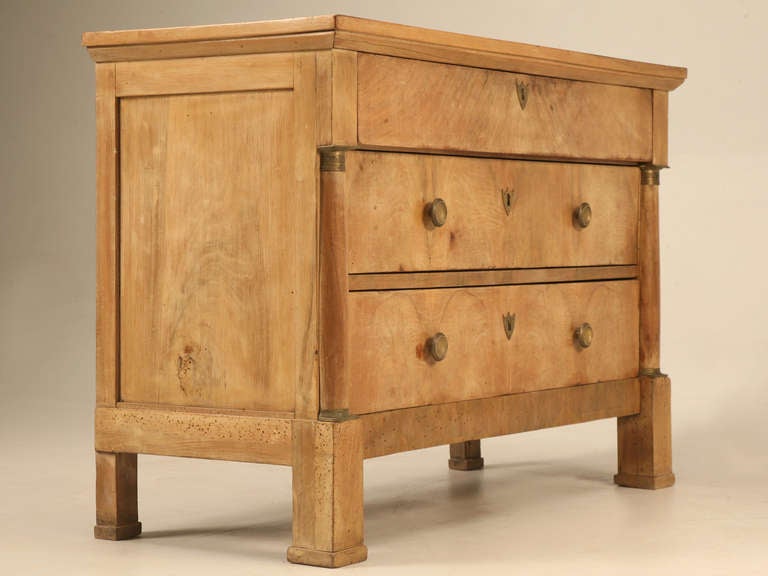 Cosmetically all original this circa 1815 French Empire commode is the kind of antique that gets us excited, particularly the sun bleached walnut case. Three deep easy operating drawers provide ample storage, while the chest itself was structurally
