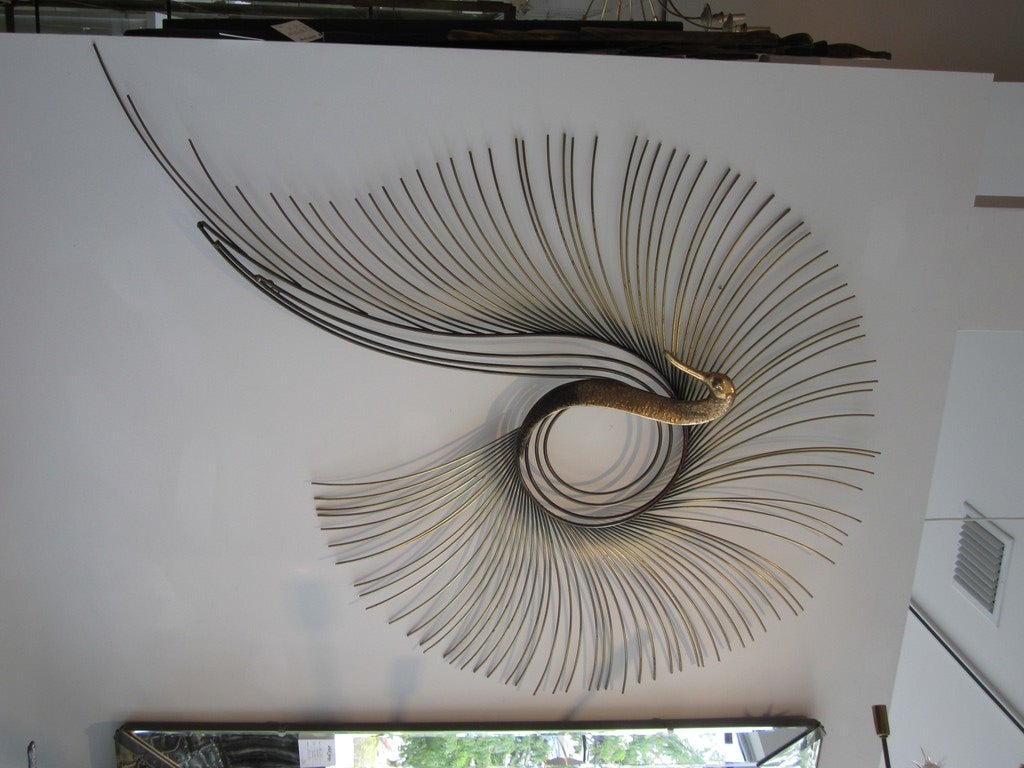 Mixed metal signed C. Jere peacock wall sculpture.