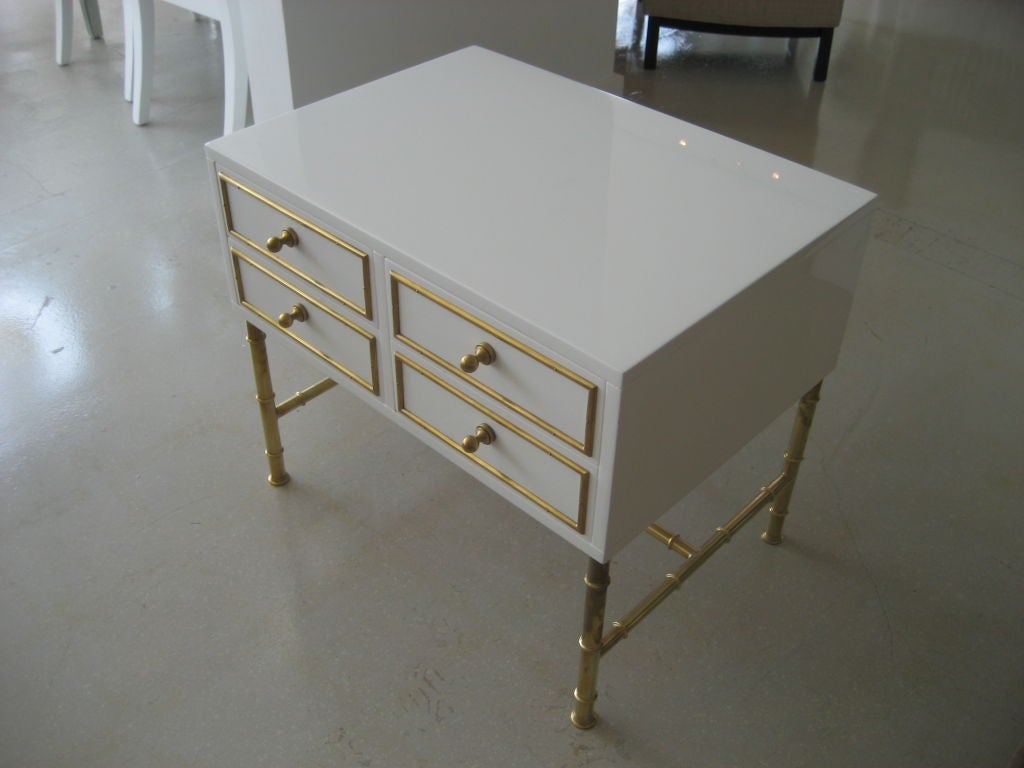 Pair of Mastercraft four drawer white lacquer chest on high polished faux bamboo brass stand. The chests are signed