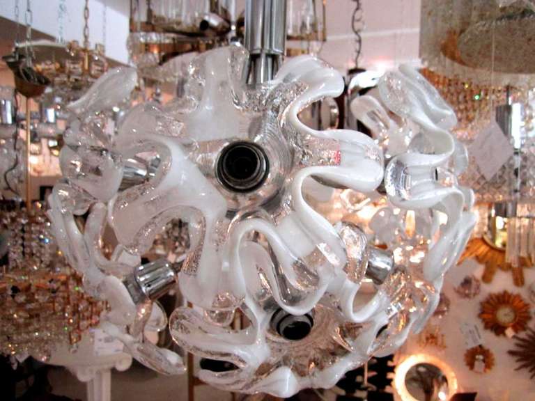 Italian chrome ball chandelier with a cluster of nine sculptural white and clear flowers with chrome hardware.
