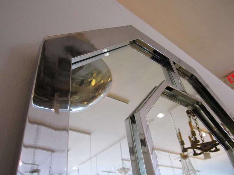 Narrow octagonal mirror in the style of David Hicks with high polished chrome edges and detail.