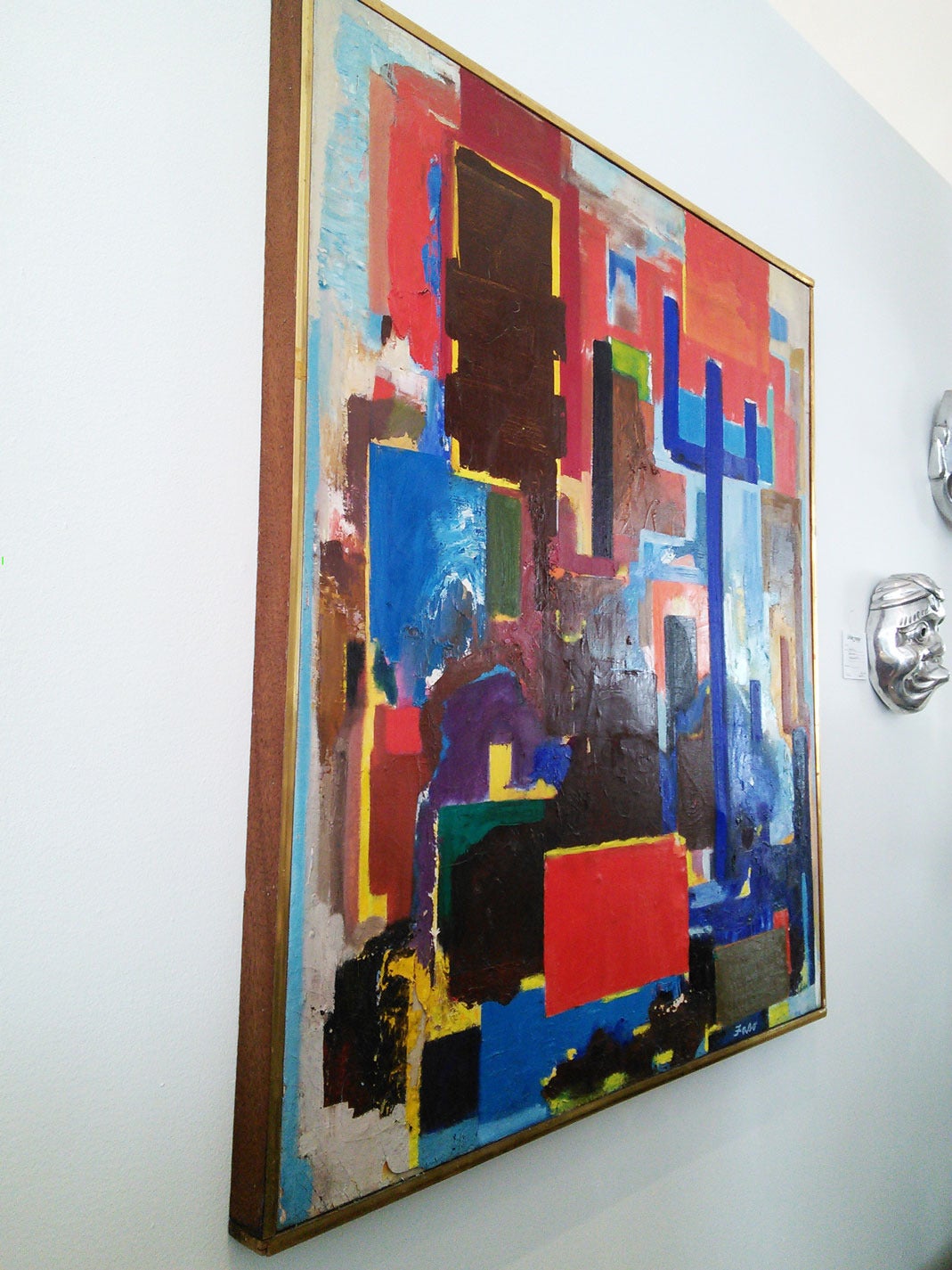 Modern abstract painting with a simple wood and brass frame, signed 