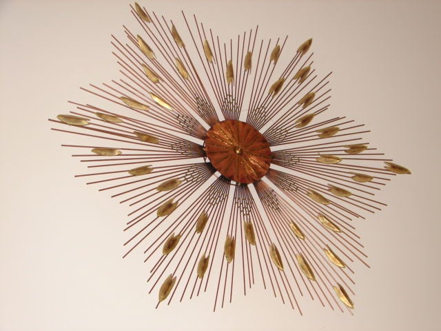 C. Jere mixed metal sunburst wall sculpture.