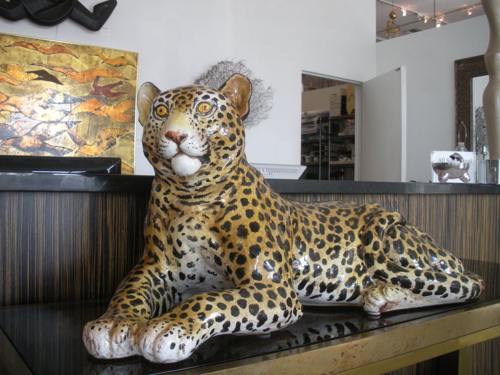 Italian glazed terra-cotta reclining leopard.