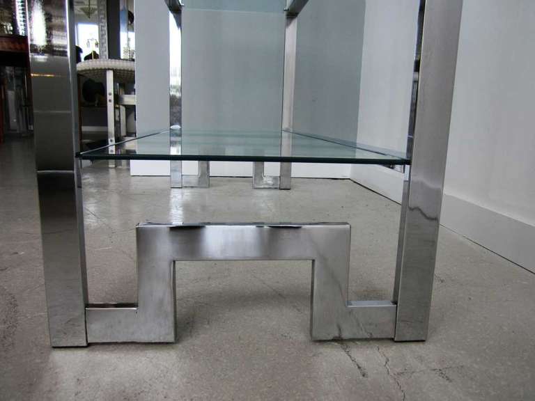 Pair of asymmetrical chrome Milo Baughman etageres with multi tiered  glass shelves. Both can be arranged as a mirror pair.