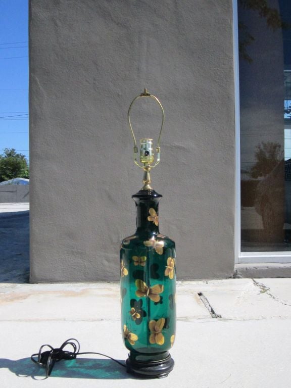 Single vintage green glass lamp with gold butterflies. The lamp has an ebonized black wood base and brass hardware- rewired.