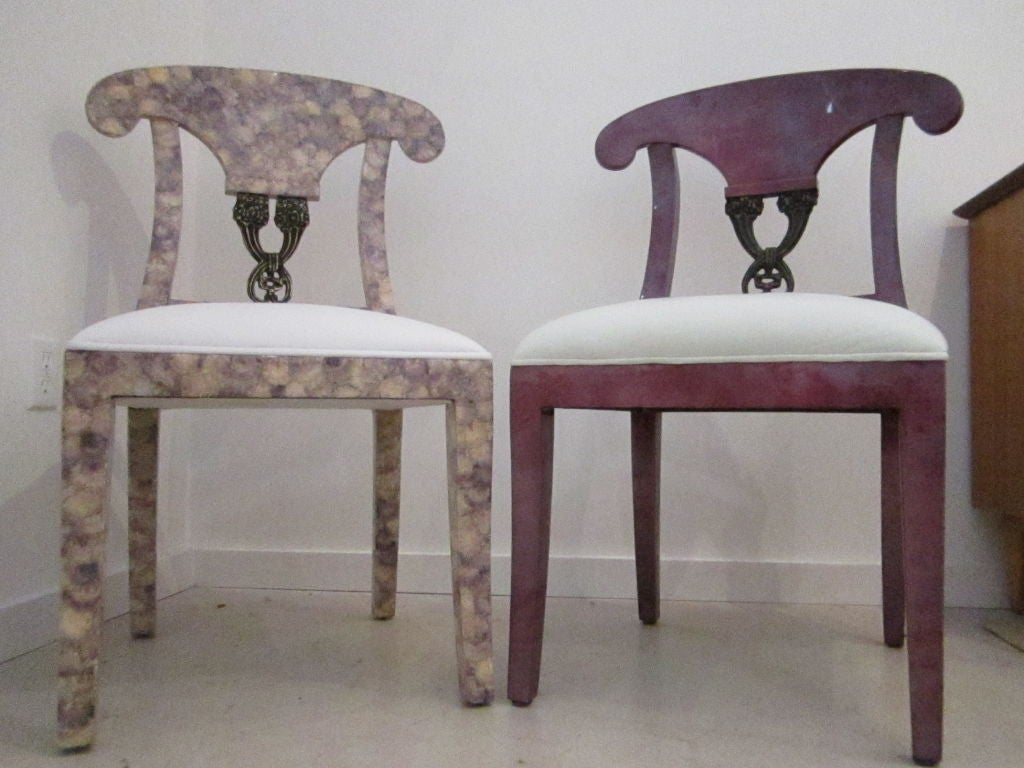 Eight dining chairsby Enrique Garces- six purple goat skin, two purple capiz shell. The chairs are upholstered in a simple white fabric.