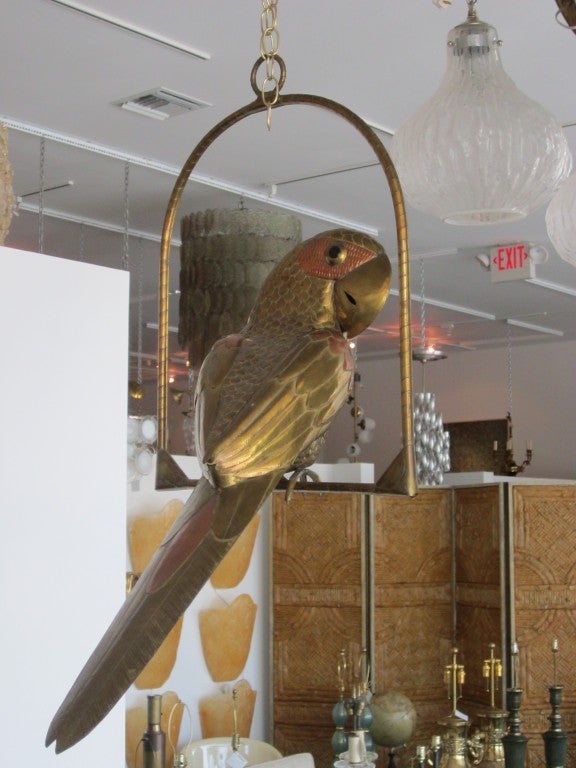 Sergio Bustamante mixed metal parrot on swinging perch.