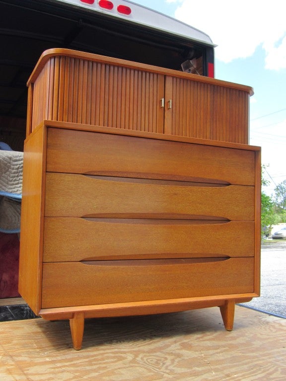 Tall chest designed by Paul Laszlo for Brown Saltman-- hosting four drawers and tambour upper case for storage.