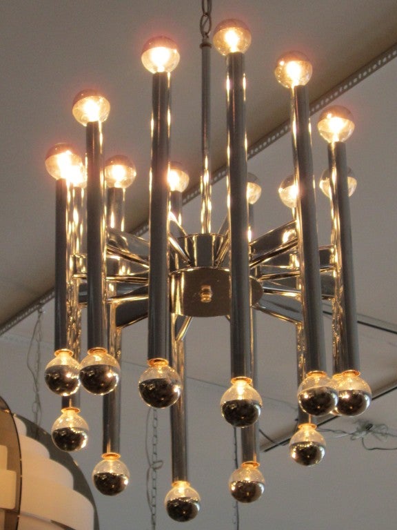Geometric chrome light fixture with cascading design-- hosting 24 candelabra bulbs.