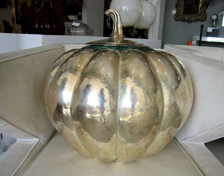 Giant hammered silver plated pumpkin, raised and hammered accented at the top with inlaid malachite & azurite mosaic.  The large lid is the top and stem of the pumpkin and it nestles on top to create a seamless look.

 Created by Emilia Castillo. 