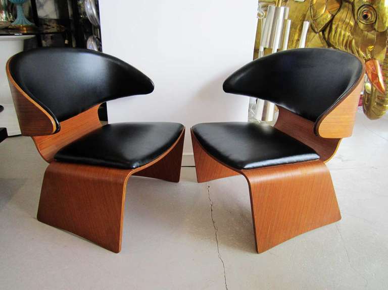 Pair of vintage original Bikini chairs designed by Hans Olsen. The chairs are  upholstered in black leather and surrounded by  warm teak wood. The chairs have the Frem Rojle Made in Denmark signature engraved into the wood under the seat.