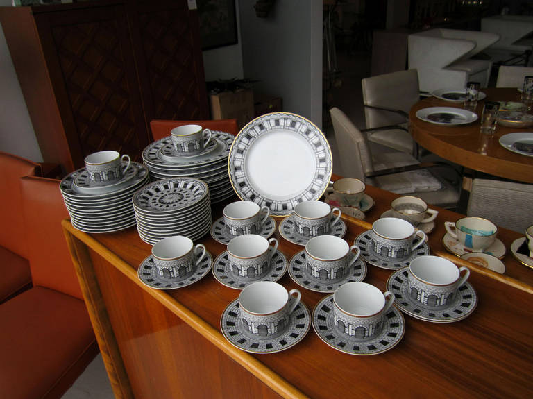 Iconic Fornasetti dinner service for 12 (less one teacup). The black and white architectural pattern is 
