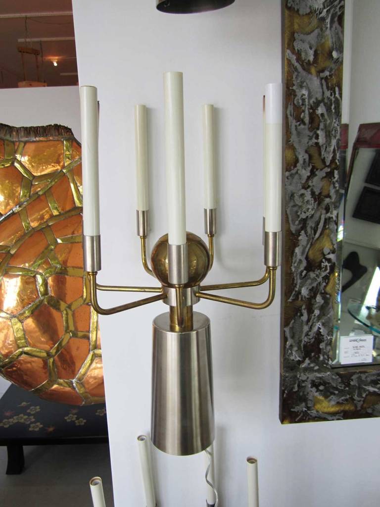 Pair of two toned high polished brass and satin finished stainless steel French sconces. Each sconce has seven sockets visible on arms and one nestled within the body to emit downward light. They take small candelabra bulbs and have been rewired for