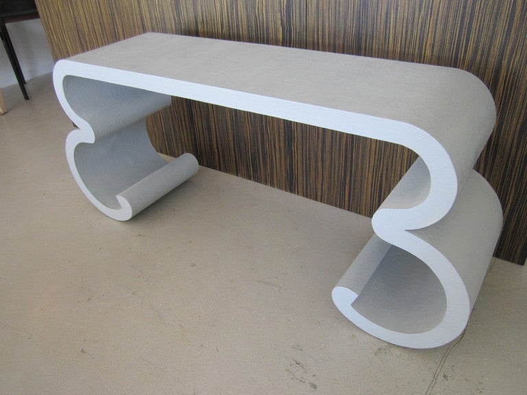 Light aqua grass cloth console table with geometric profile in the manner of Karl Springer.