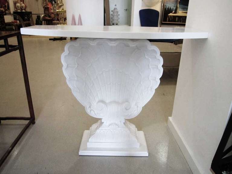 White Hollywood Regency shell console table by Grosfeld House, with plaster shell, wood base and top