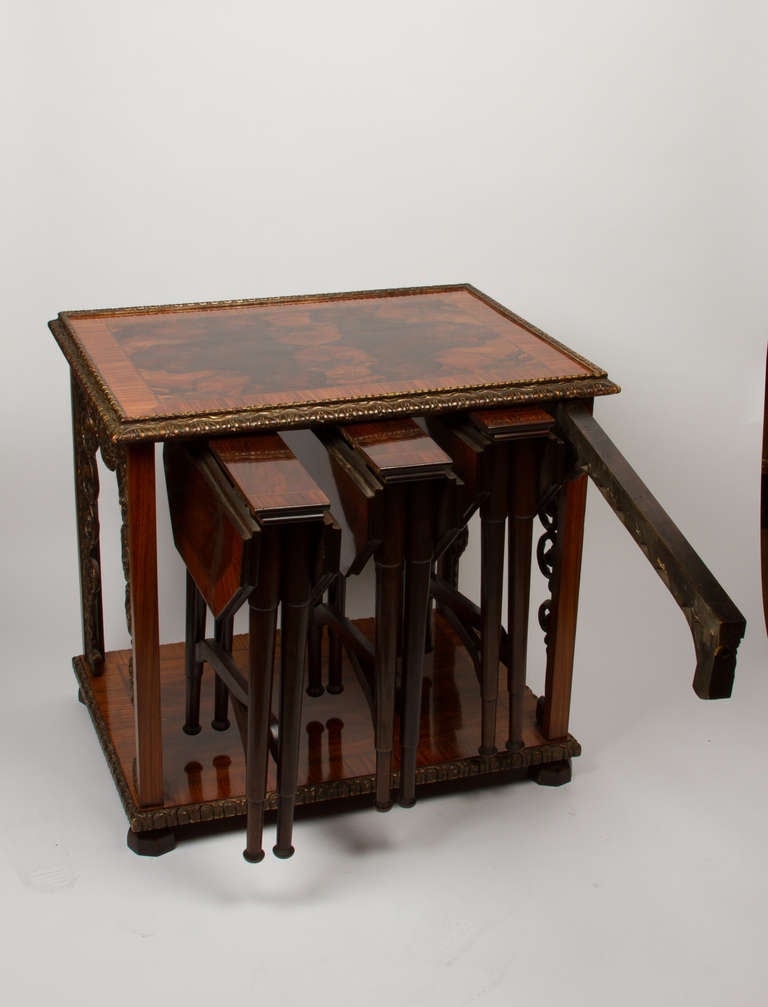 A Dutch marquetry inlaid Baroque style rectangular nesting table with 4 square and tapered legs joined by stretcher and ball shaped feet, the top sides and feet having floral motif marquetry inlay.