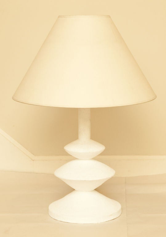 An American plaster table lamp with 3 disc shaped elements of graduated size below round stem fitted with electric socket. Designed by Alberto and Diego Giacometti for Jean Michel Frank, 1935. Manufactured by American company LCS.