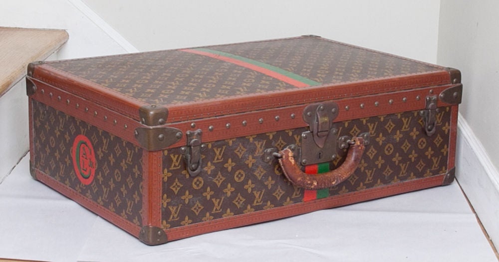 A set of 3 Louis Vuitton suitcases comprised of one pair and a smaller companion suitcase with signature monogram canvas bound in leather with nails, the signature embossed on the interior with peach colored carton tray with straps, the cases with