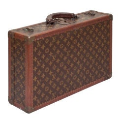 A Louis Vuitton Suitcase with Signature Canvas Cover