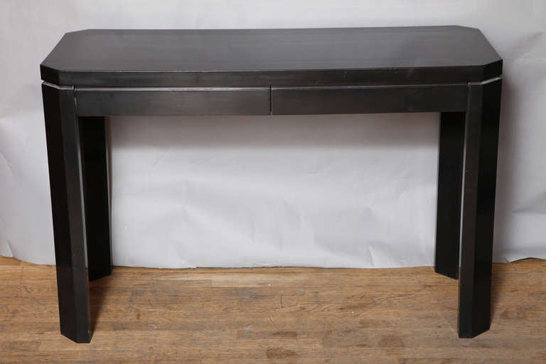 A pair of Jules Wabbes (Belgian, 1919-1974) black lacquered console tables. Each rectangular top with squared corners and octagonal legs having two drawers in the apron and finished on four sides. Can be sold separately. 