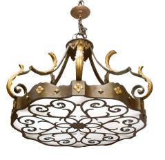 A Forged Iron Chandelier with Open Fret Design on Underside