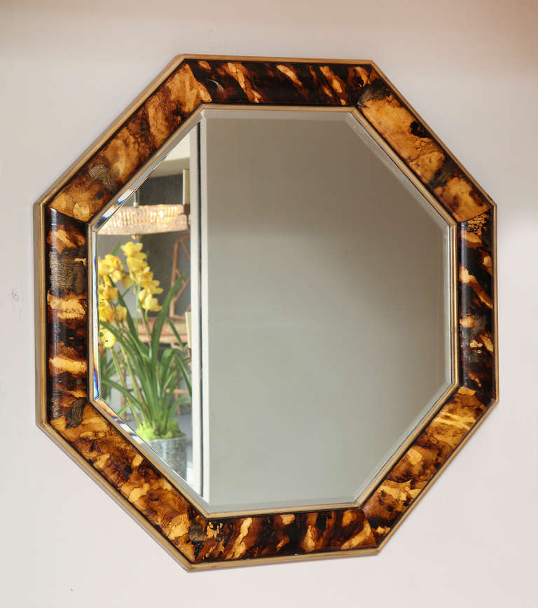 An American octagonal mirror with faux tortoise shell painted painted frame and beveled glass mirror.