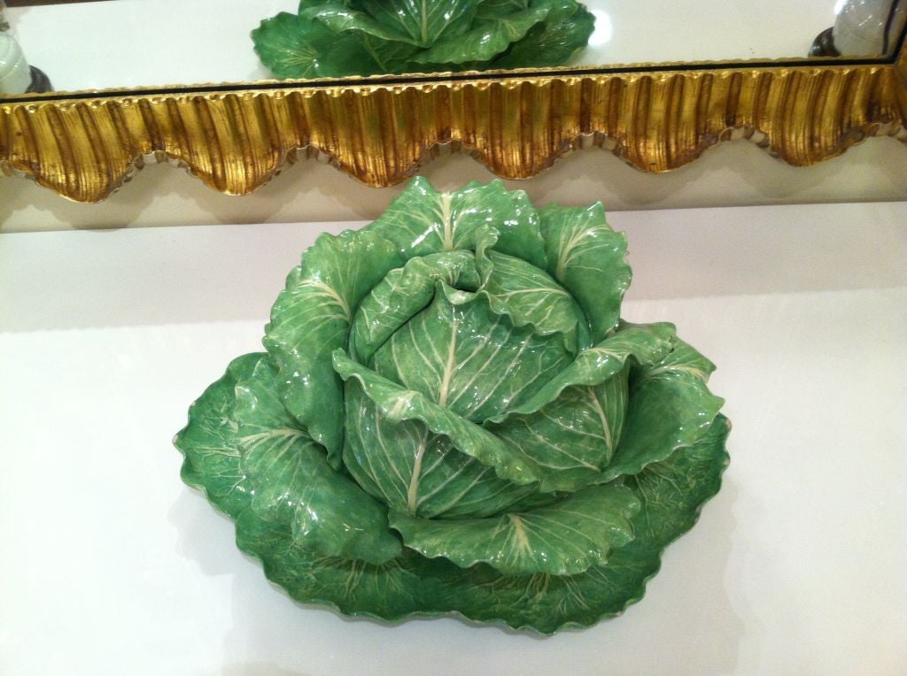A Dodie Thayer three piece covered tureen with under plate, the naturalistic lettuce form center with lid signed on the underside.  Retailed by Palm Beach boutique “Au Bon Gout” dated 1969.