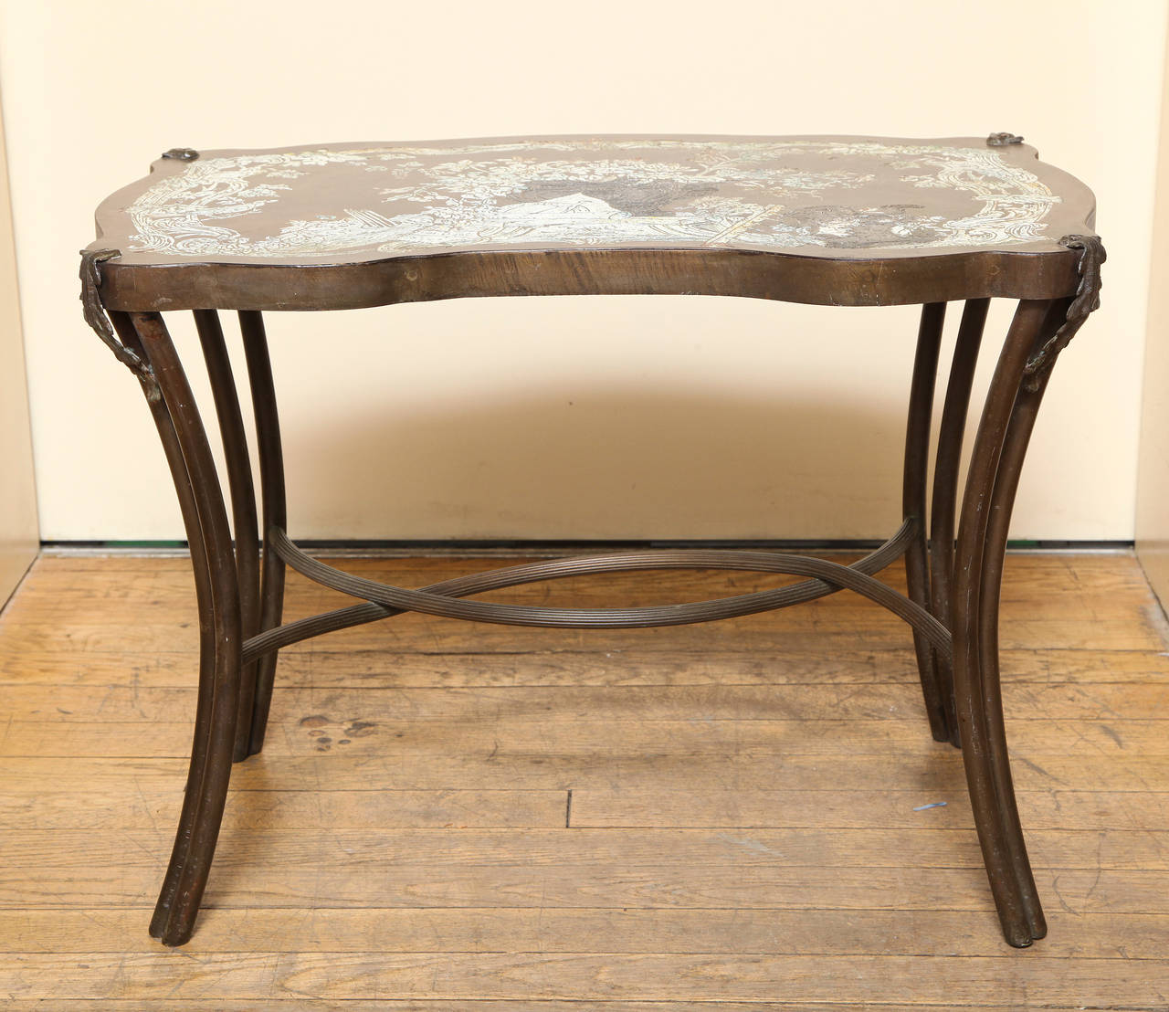 A rectangle serpentine edge low side table by Philip and Kelvin LaVerne, with tapering in swept legs in the form of two round turnings, with applied leaf decoration at each corner. The four legs joined by c-shaped stretchers. The top decorated with