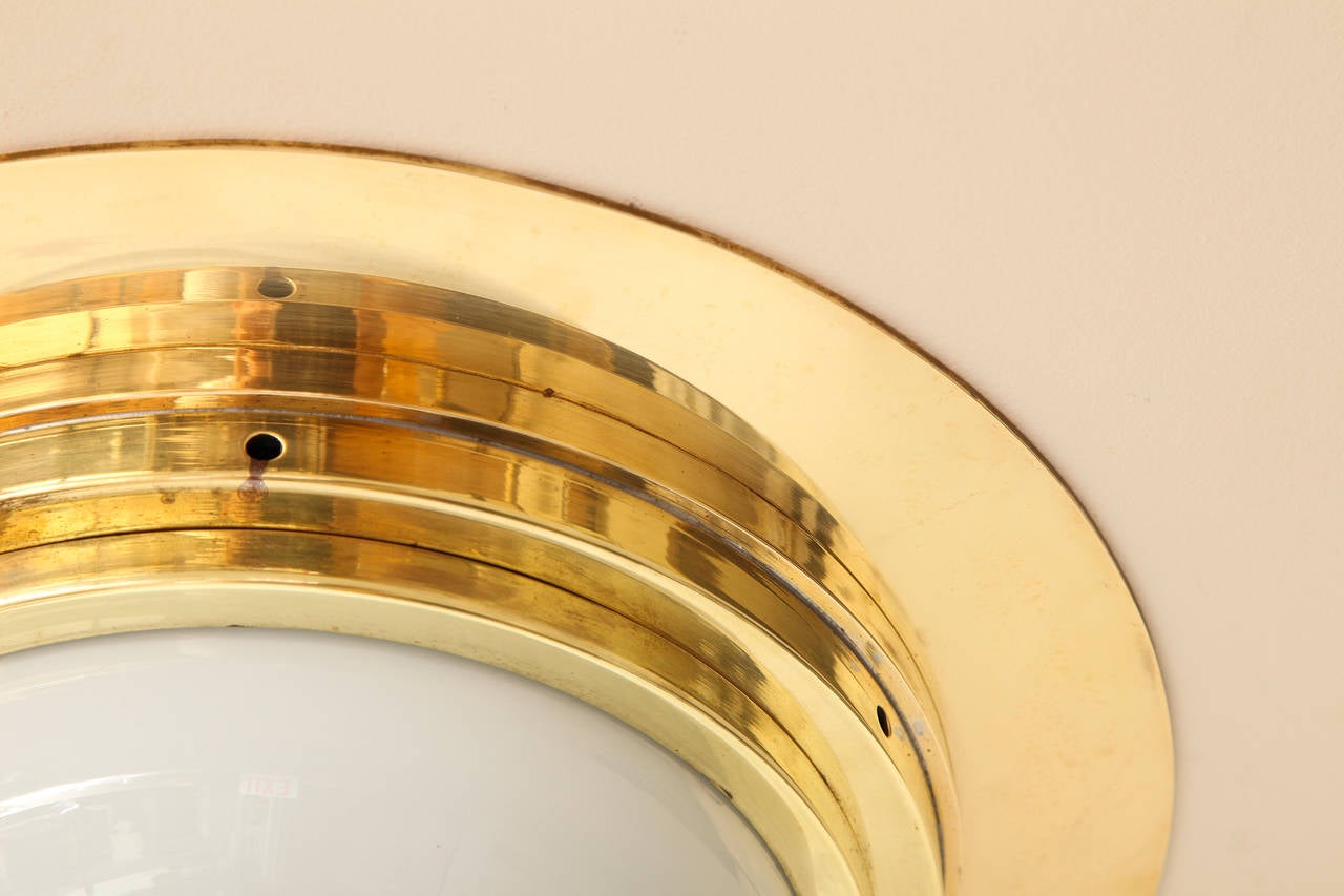 A Single Bronze Flush Mounted Fixture With Half Dome Glass 1