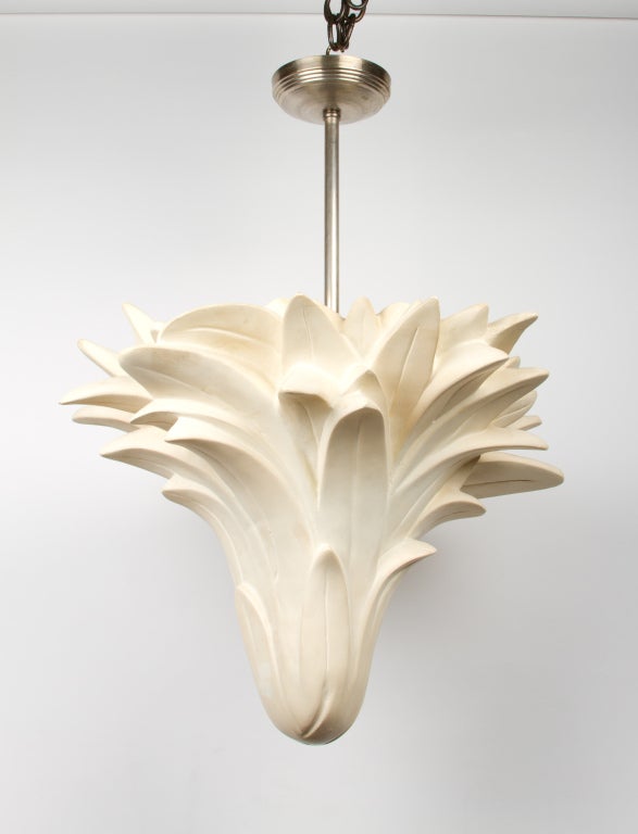 A new Serge Roche style resin uplight chandelier with chalky white finish, the vase shaped body formed by palmette leaves, having two concealed electric sockets suspended from metal stem with canopy. Two Edison sockets