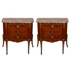 A pair of French Louis XV style three drawer tables