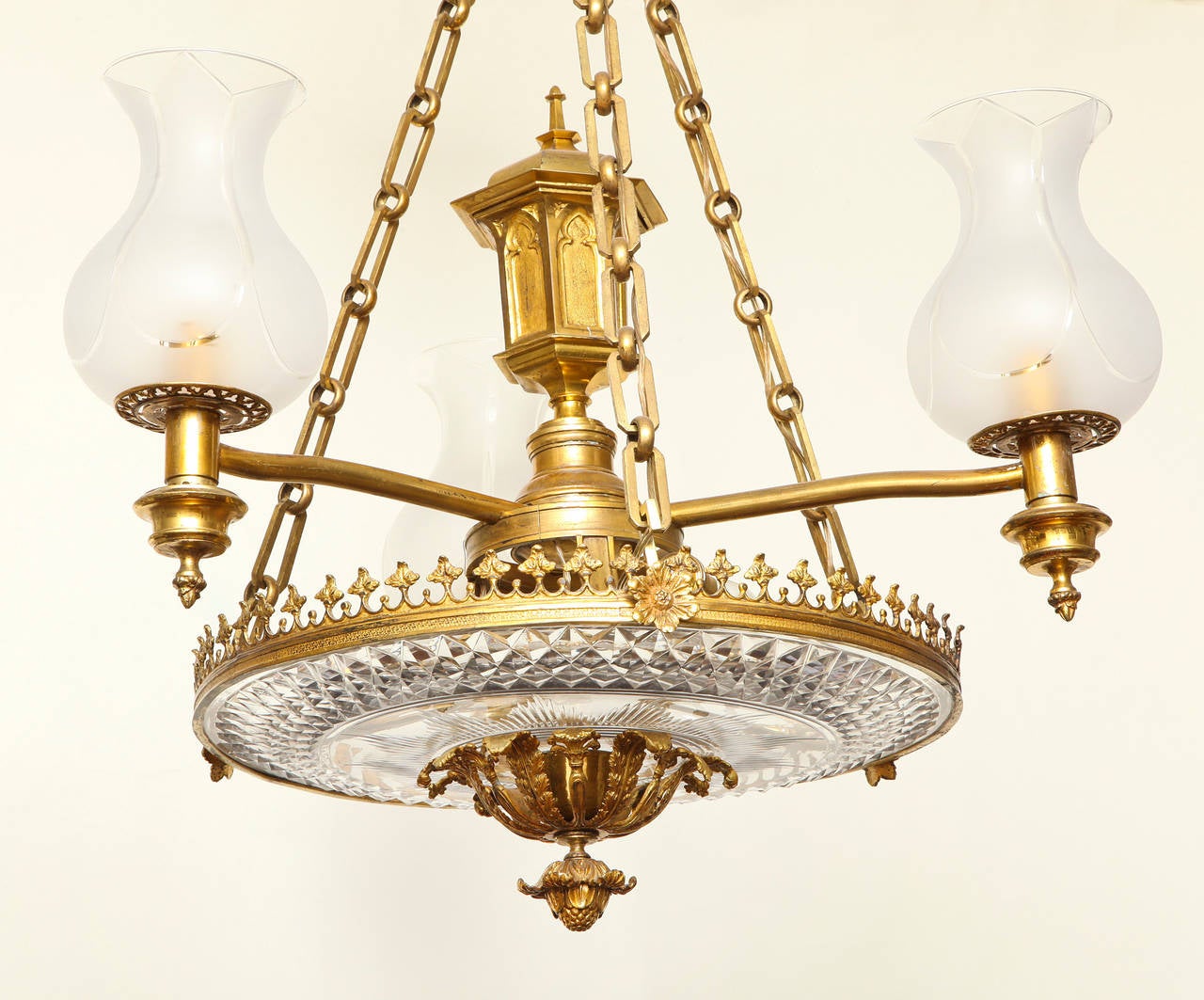 English late Regency colza ceiling fixture. The hexagonal center gilt bronze oil vessel with Gothic arches issuing three arms secured to gilt bronze ring with trefoil gallery securing heavy cut crystal dish illuminated by means of three candelabrum