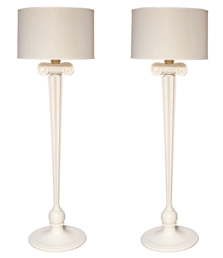 A pair of neo-classic design standing lamps from the Eden Roc Hotel, Miami, Florida. The round resin bases issuing tapering stems below stylized Ionic capitals.