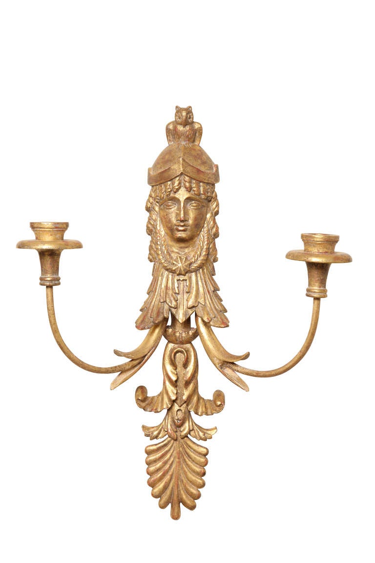 A pair of Empire style giltwood two-light sconces, the backplate in the form of the harvest goddess Ceres, issuing two candle arms, the bottom half in the form of an anthemion, wired for electricity, two pairs available.  Attributed to Edward F.
