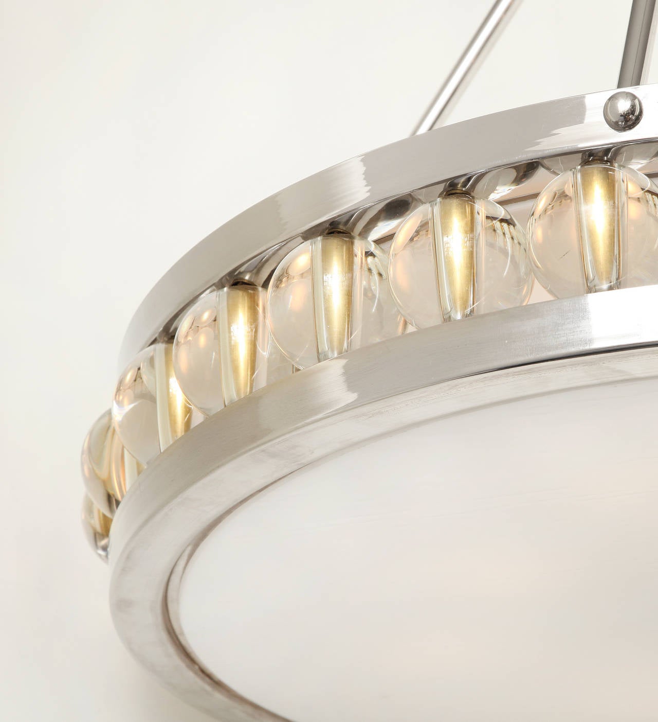 A large round polished nickel pendant ceiling fixture suspended from four rods and canopy, 24