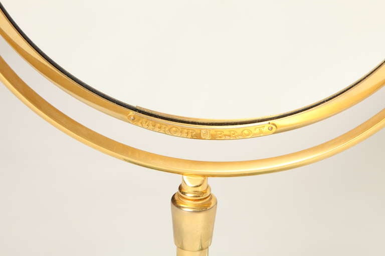 Glass A Round Gilt Metal Magnifying Mirror