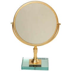 A Round Gilt Metal Magnifying Mirror