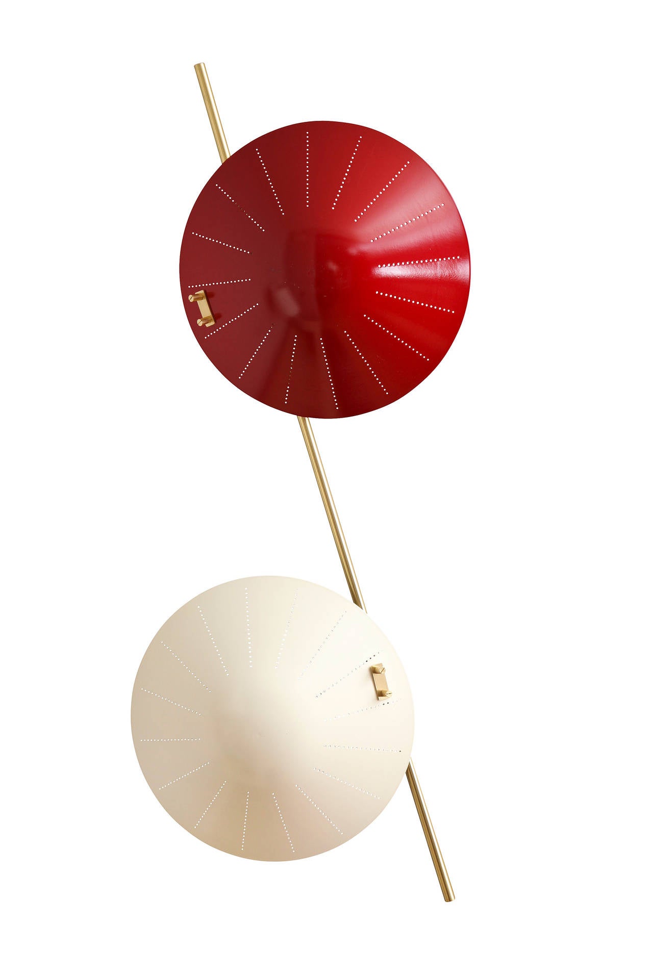 A pair of two light wall sconces each socket concealed by round shallow dish shaped shade with sunburst pattern perforation emitting light. The upper shade painted red, the lower shade painted white connected by diagonal brass rod.
