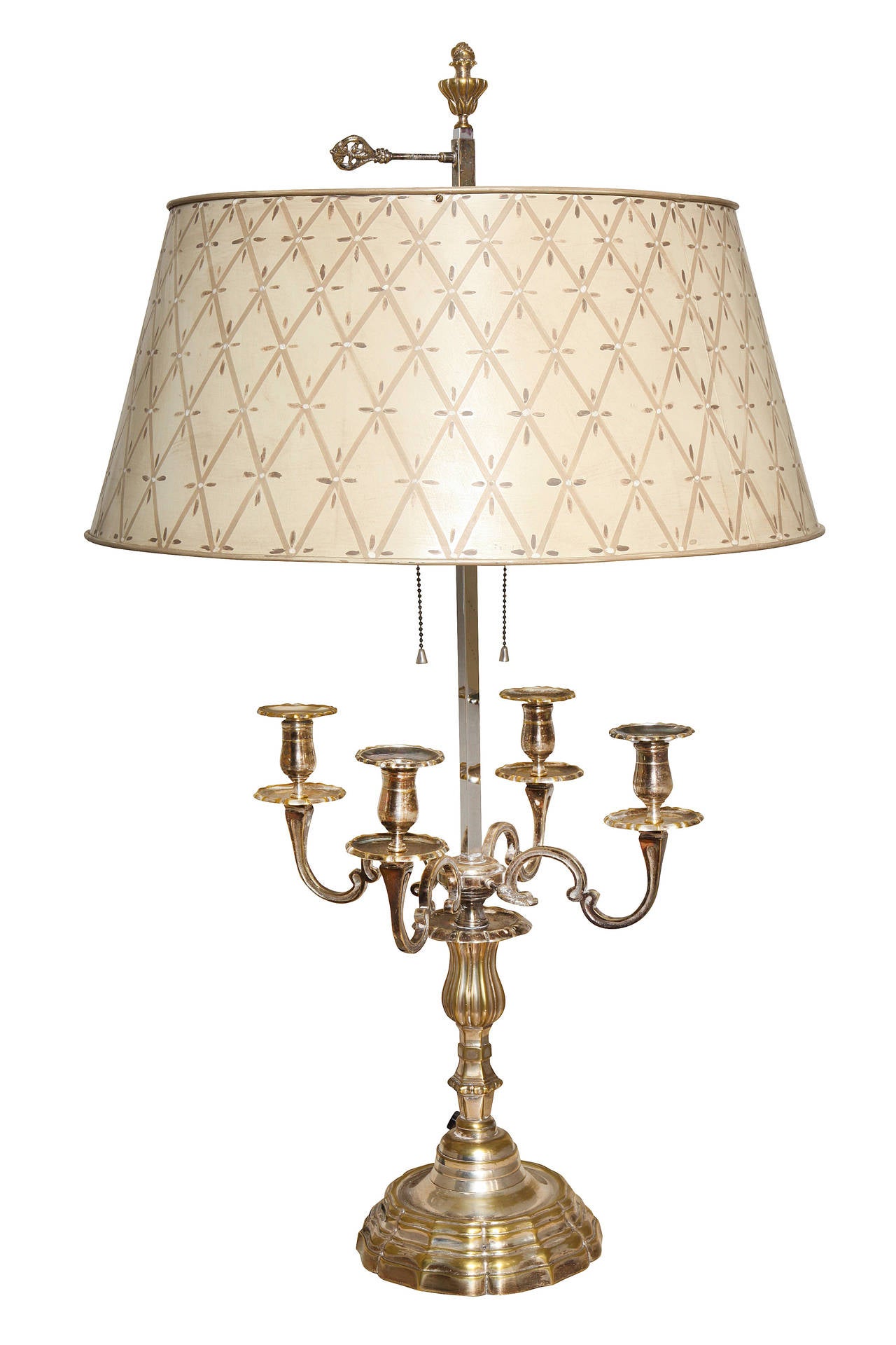 A pair of French Regence style silver-plated bronze four-light bouillotte lamps, the candles concealed by hand-painted tole shade of adjustable height.