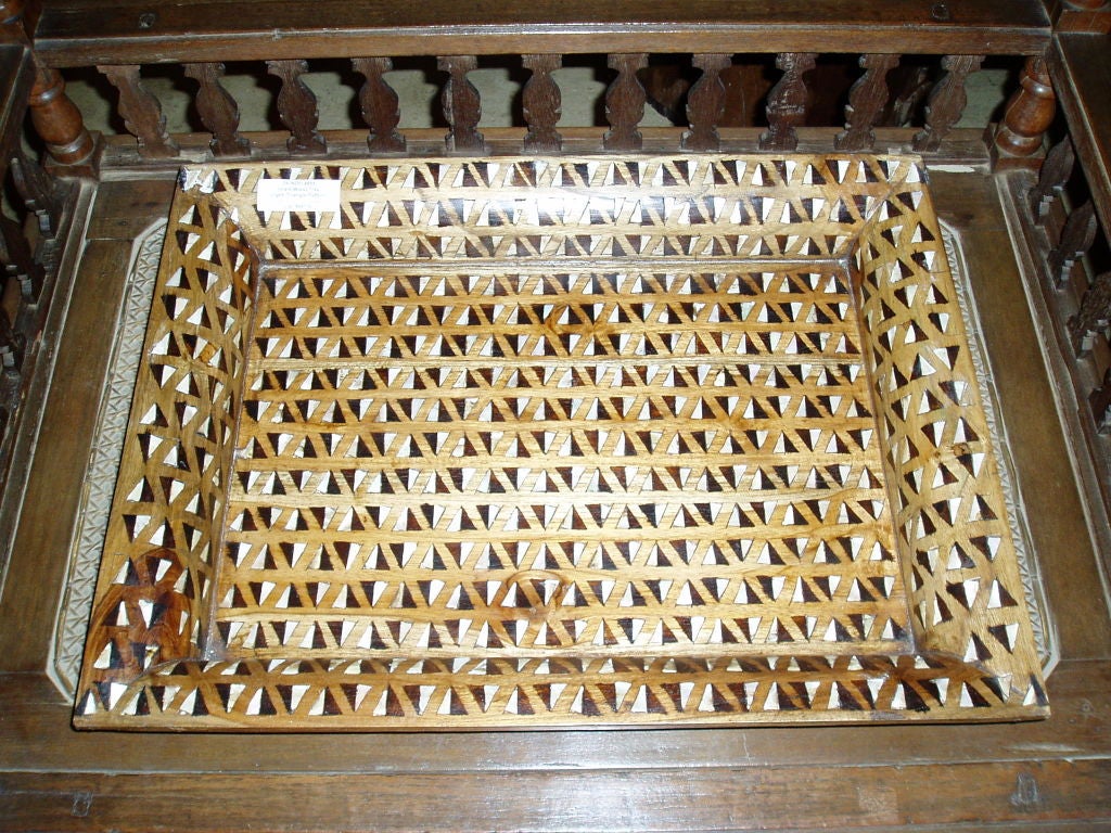 A selection of wood trays with mother-of-pearl inlays. Four inlaid patterns available. Two tray sizes. Wood tones vary, darker to lighter. Prices vary. Price and size of larger tray shown below.
