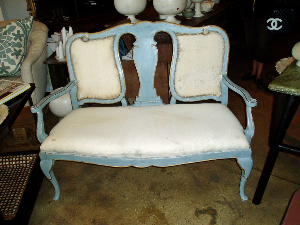 A Gustavian bench, Swedish, 19th century. Without upholstery. 
Its original pale blue painted frame, shows the classic aged patina which characterizes the style.  With the combination of ornate neoclassic detailing and soft, soothing color palettes,