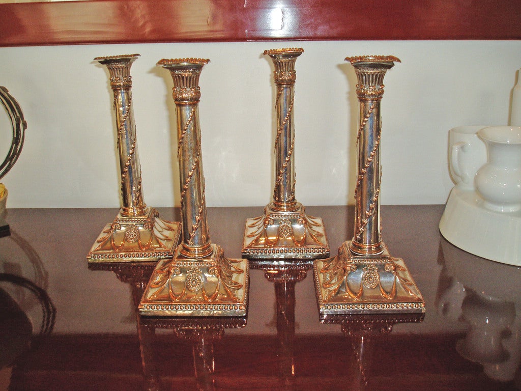A set of four Sheffield plate candlesticks, English, circa 1785. Sold as a set of four.