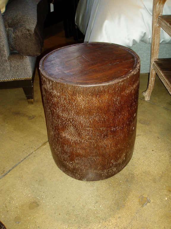 A hand-carved coconut wood drum table