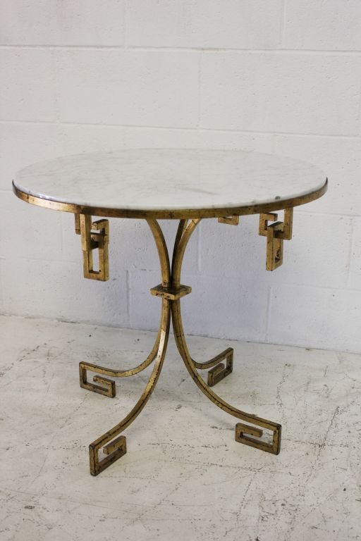 Arturo Pani gilt over iron marble-top side table.

Greek key design.