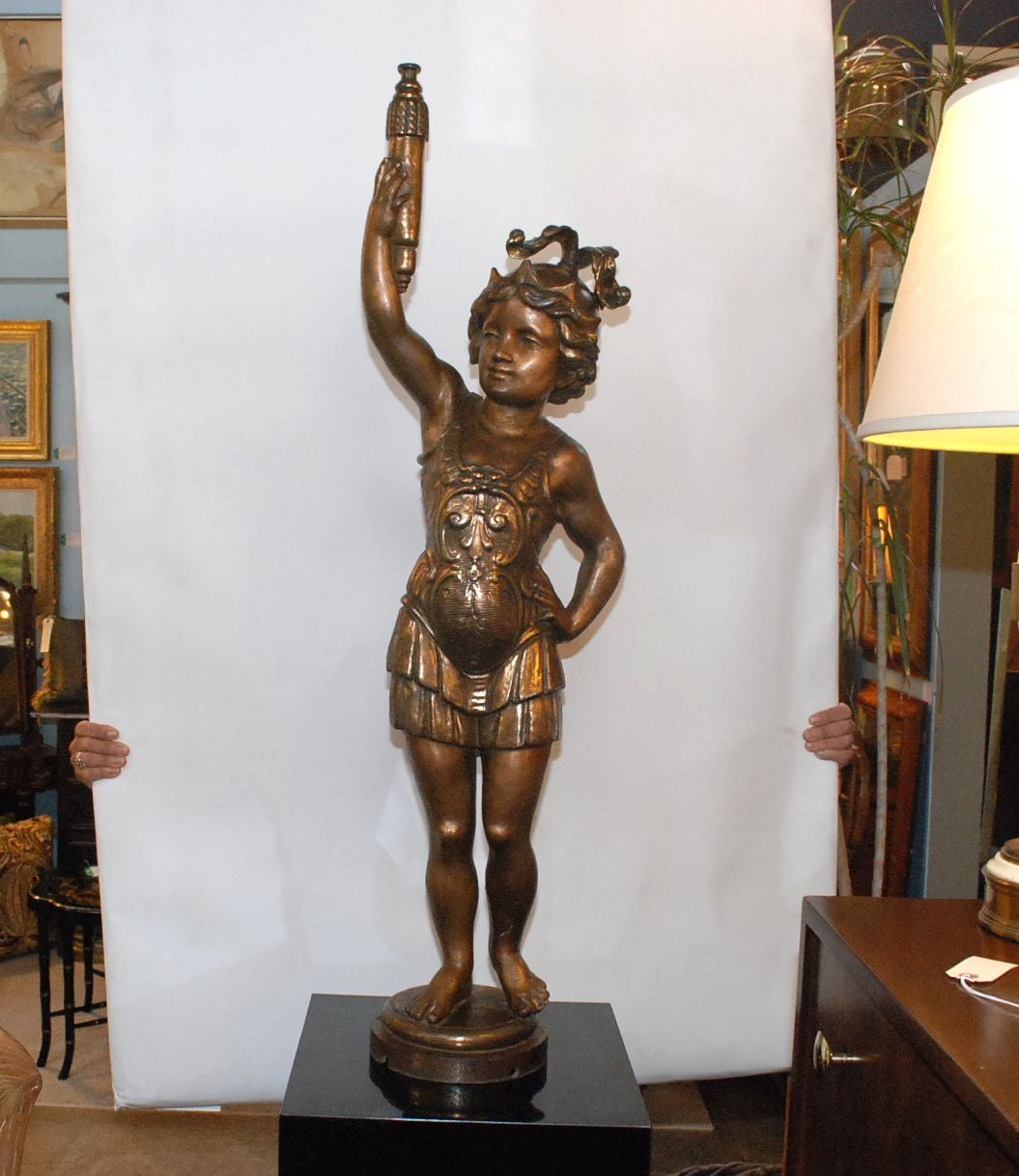 An amazing vintage Italian cast iron sculpture of a Roman lady holding up a torch. There are a total of four holes in the base (one completely cut-out) for use should the sculpture be converted into a lamp. There is also a removable screw in the