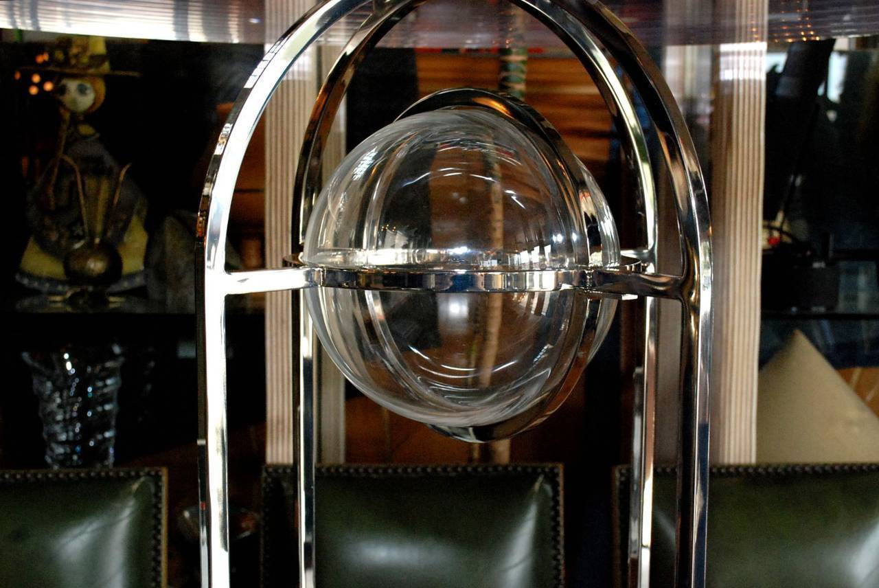 An amazing Charles Hollis Jones bullet dining table. Base is made of nickel-plated steel with a whimsical Lucite sphere enclosed in the centre of the table. Lucite top is 1.25 inches thick. Base is signed by the designer.