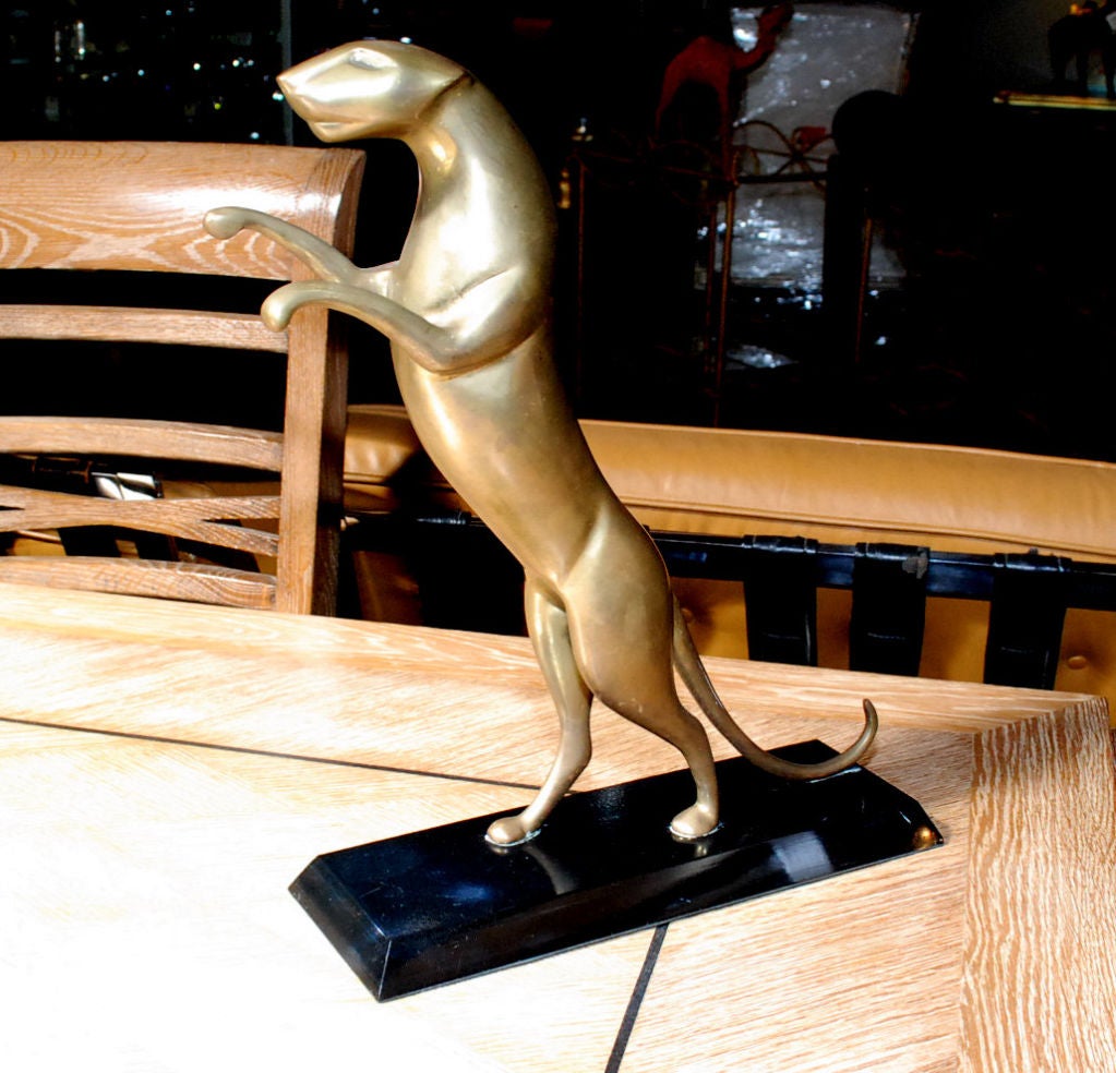 ELEGANT 1960'S BRASS PANTHER SCULPTURE ON BLACK LACQUER WOOD BASE.