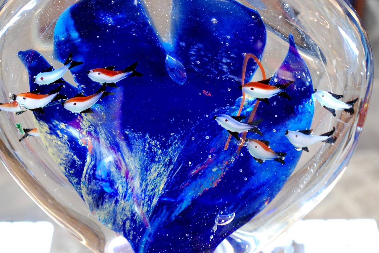 A wonderful vintage Murano glass aquarium featuring schools of fish. It has a different colorful design on each side.